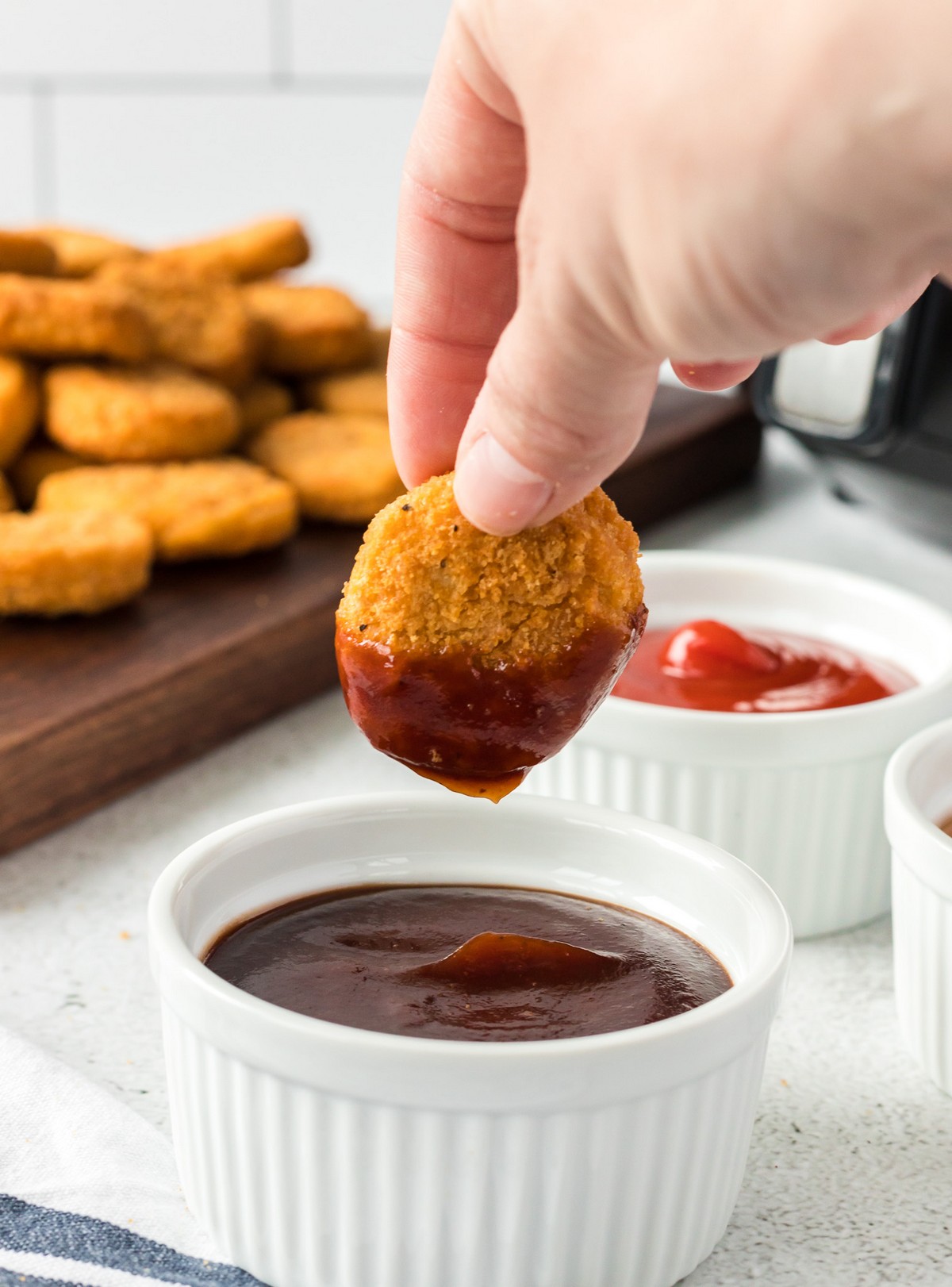 dipping chicken nugget in bbq sauce