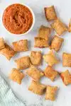 pizza rolls scattered around sauce