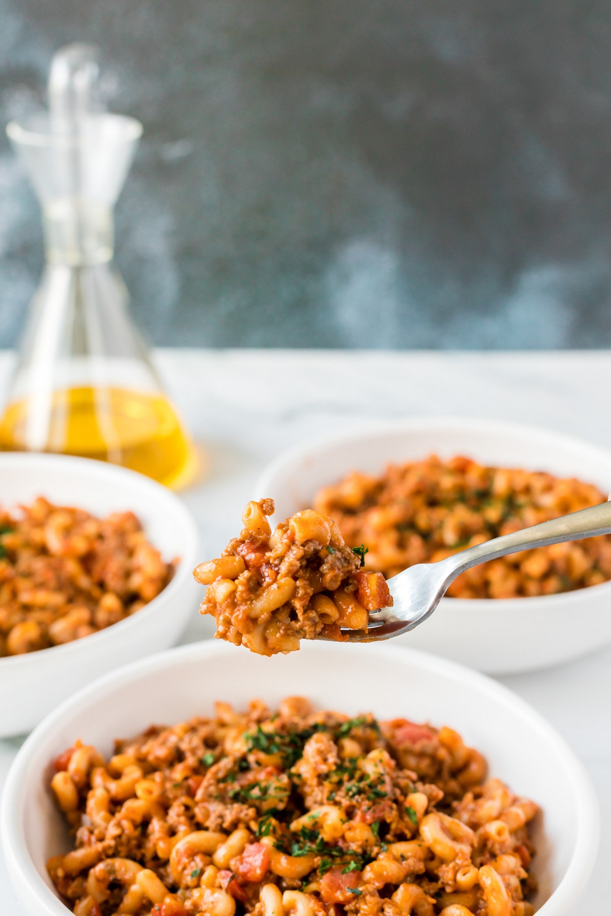 fork with goulash and three bowls