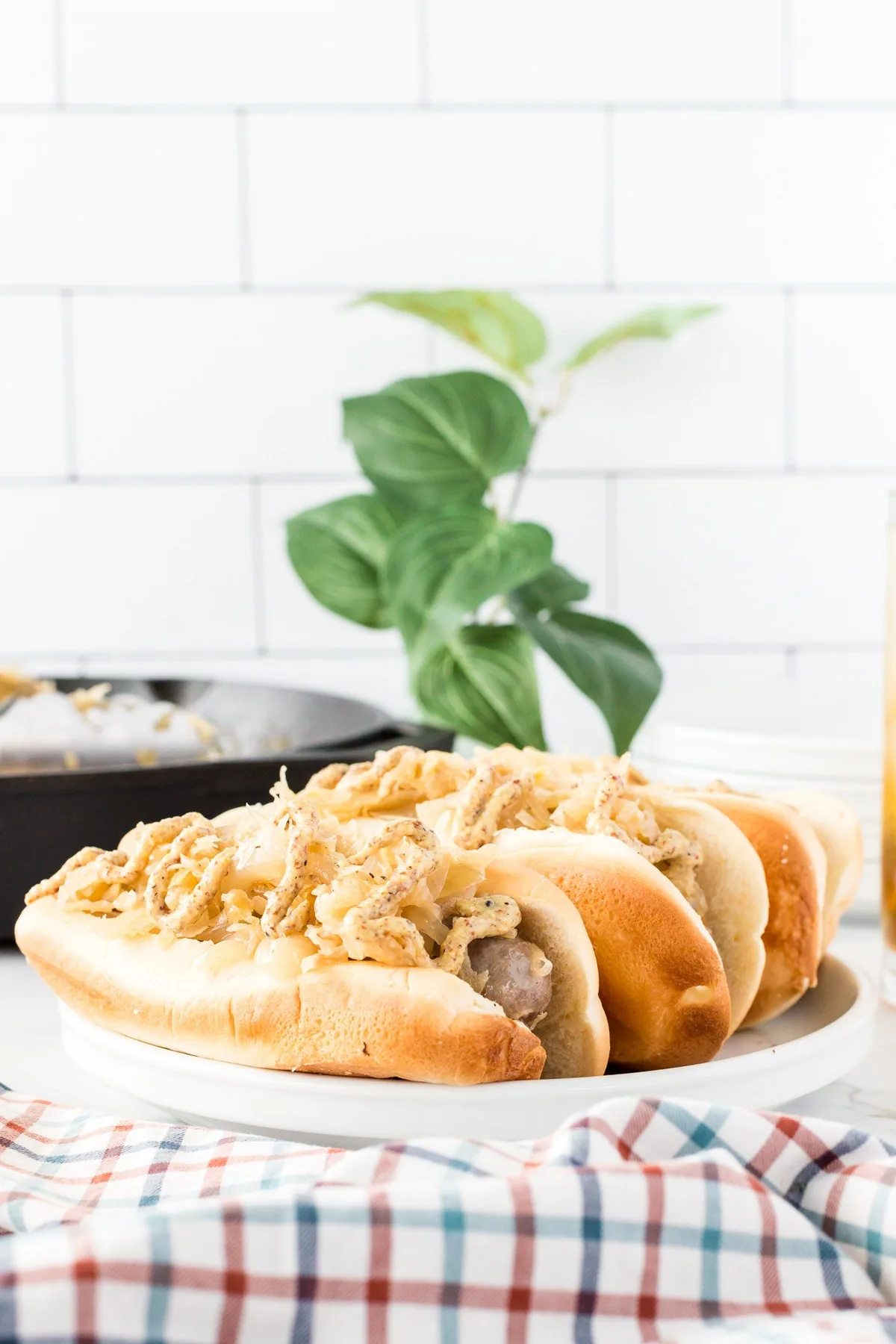 bratwurst in bun with sauerkraut and onions