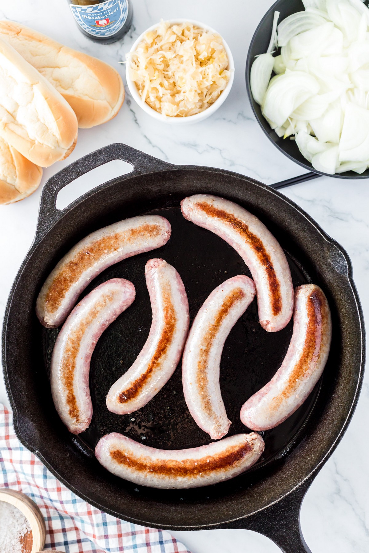 seared bratwursts in skillet