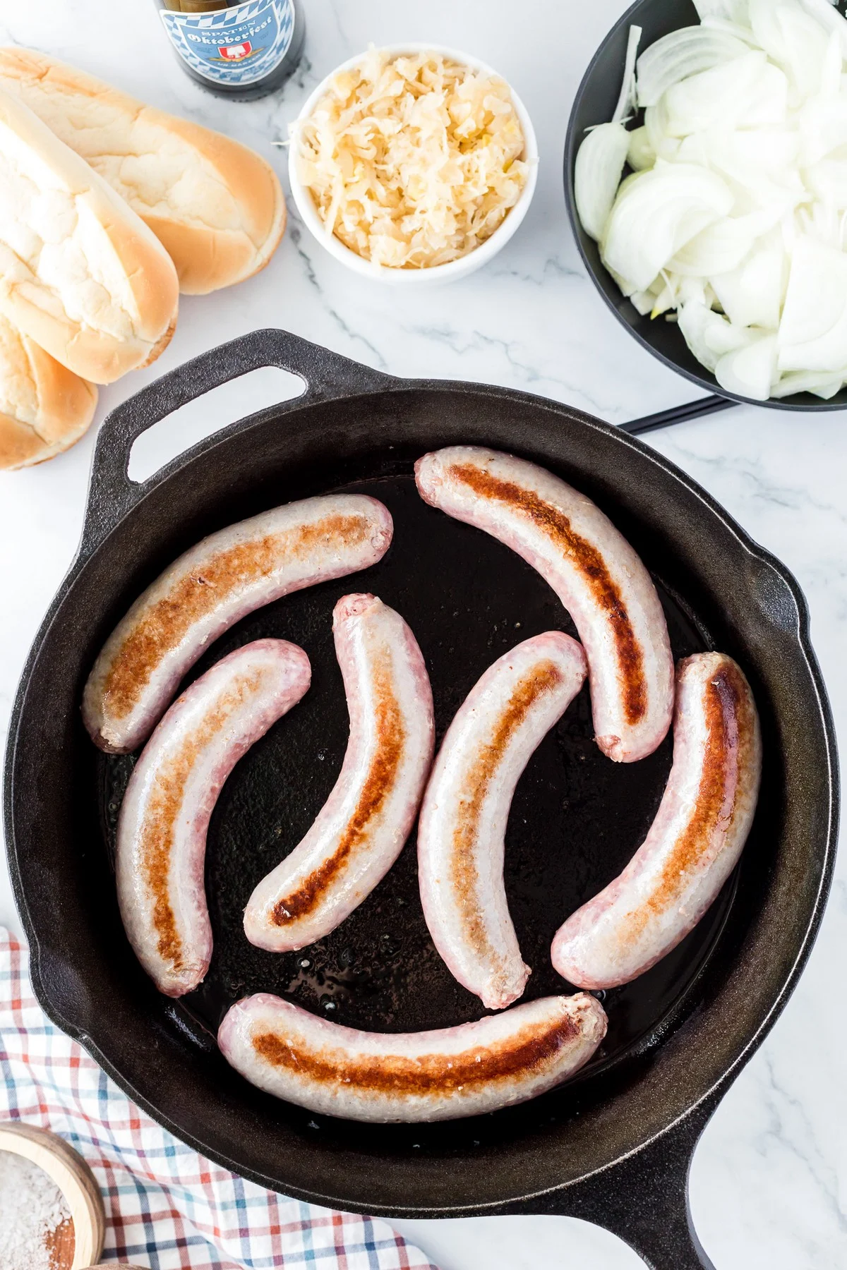 seared bratwursts in skillet