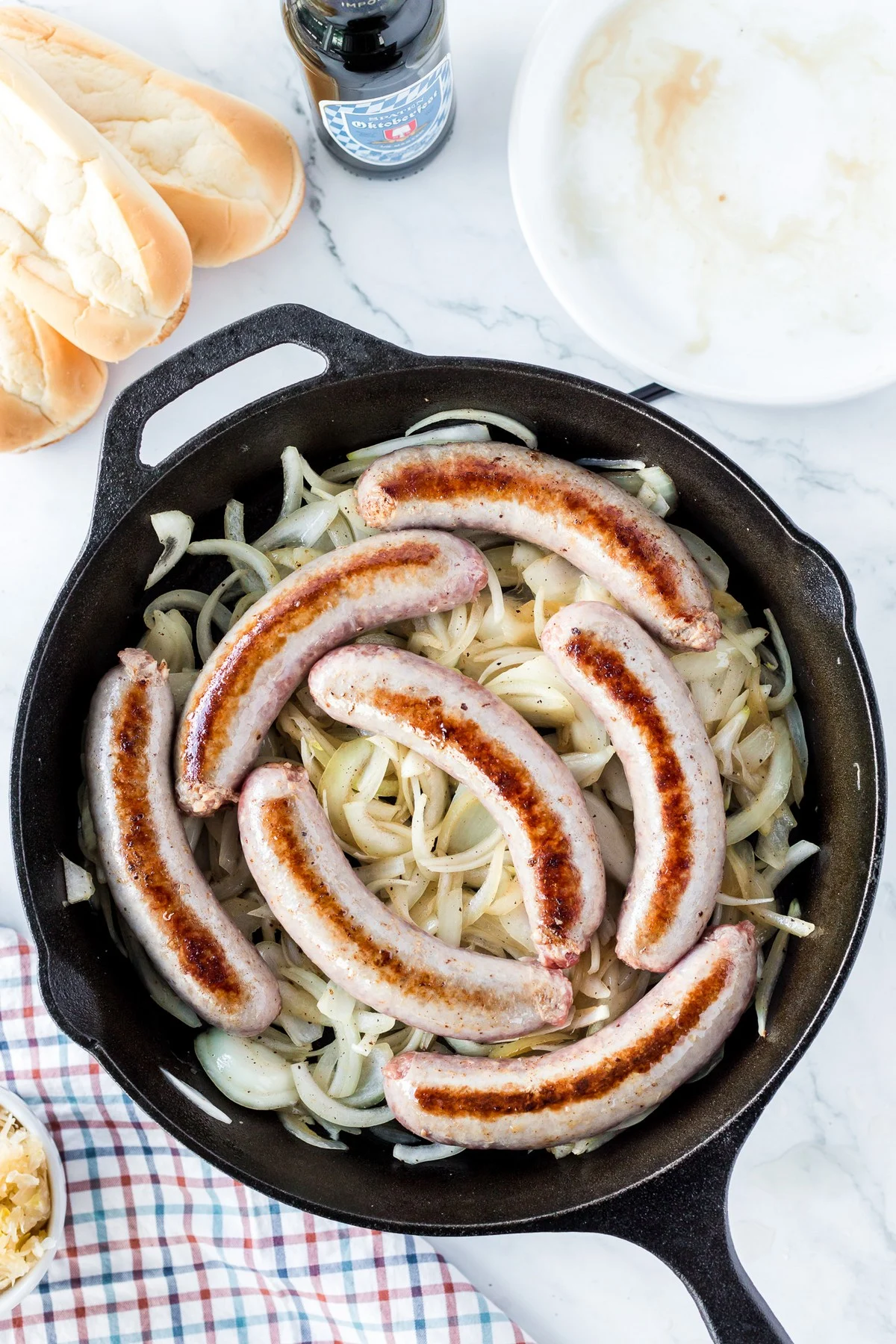 bratwursts and onions in skillet