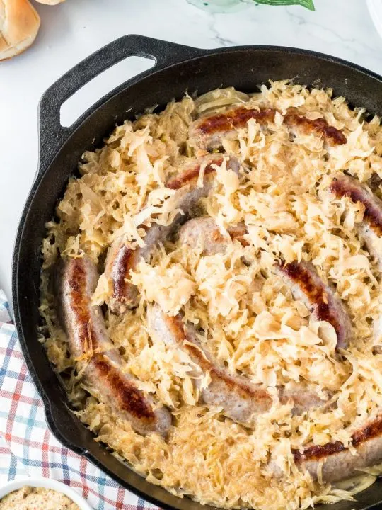 prepared beer braised bratwursts with sauerkraut and onions