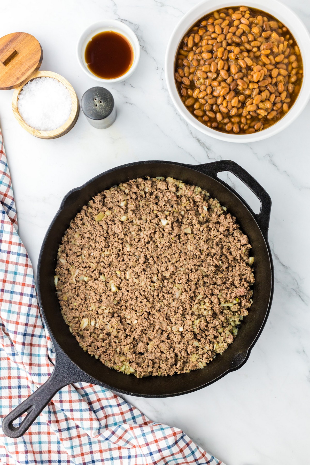 browned ground beef and onion in black iron skillet