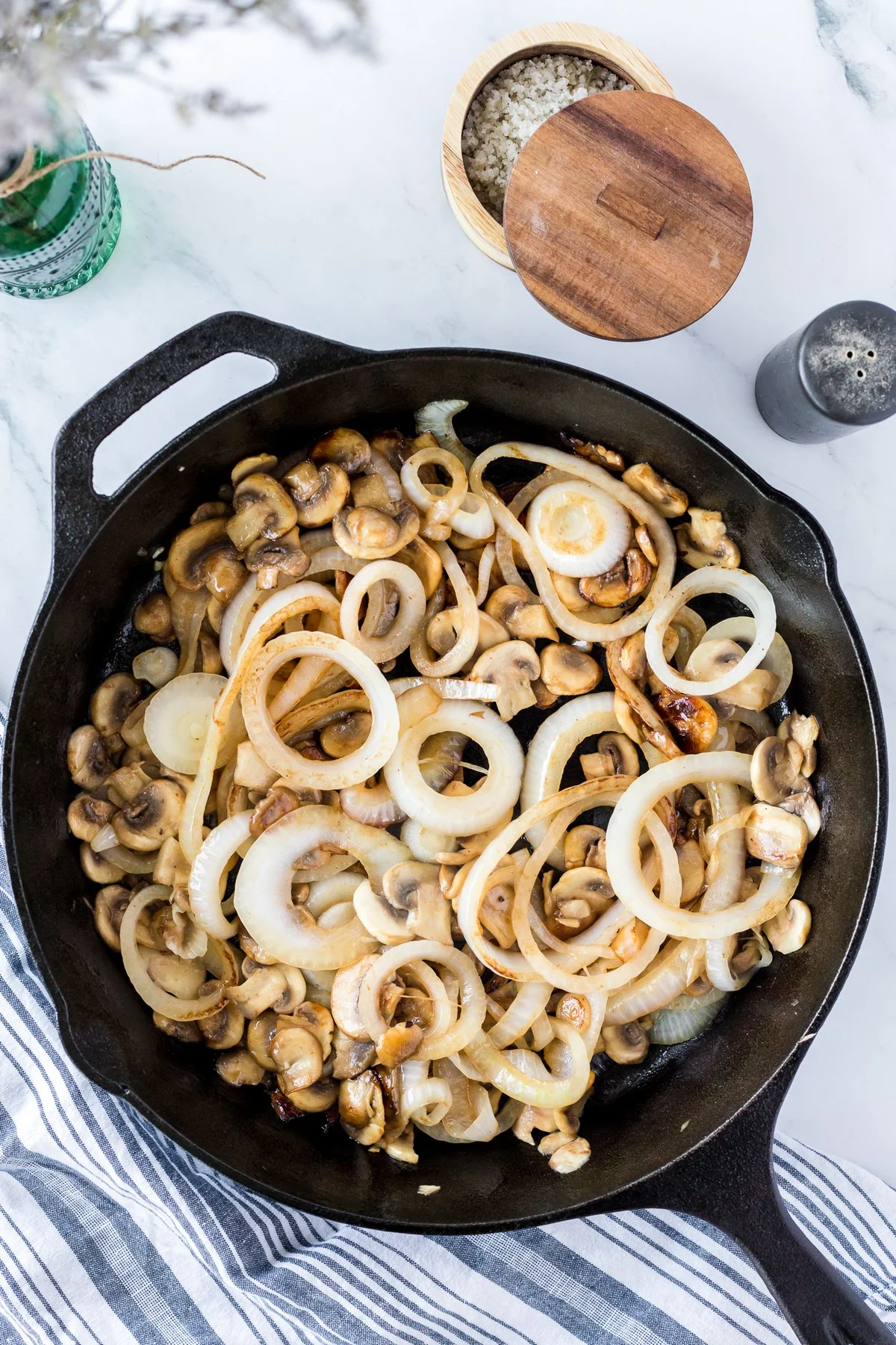 sautéing onions and mushrooms in a skillet