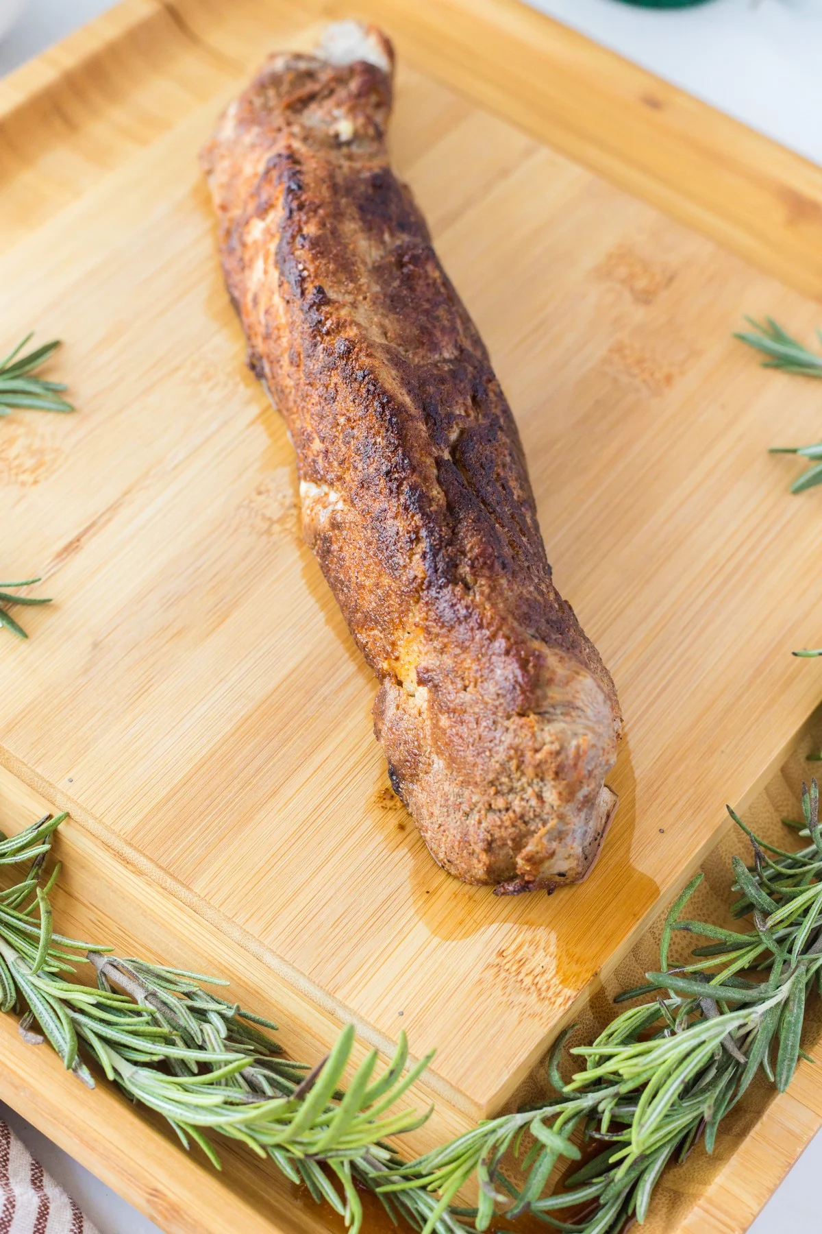 whole roasted pork tenderloin on a cutting board unsliced