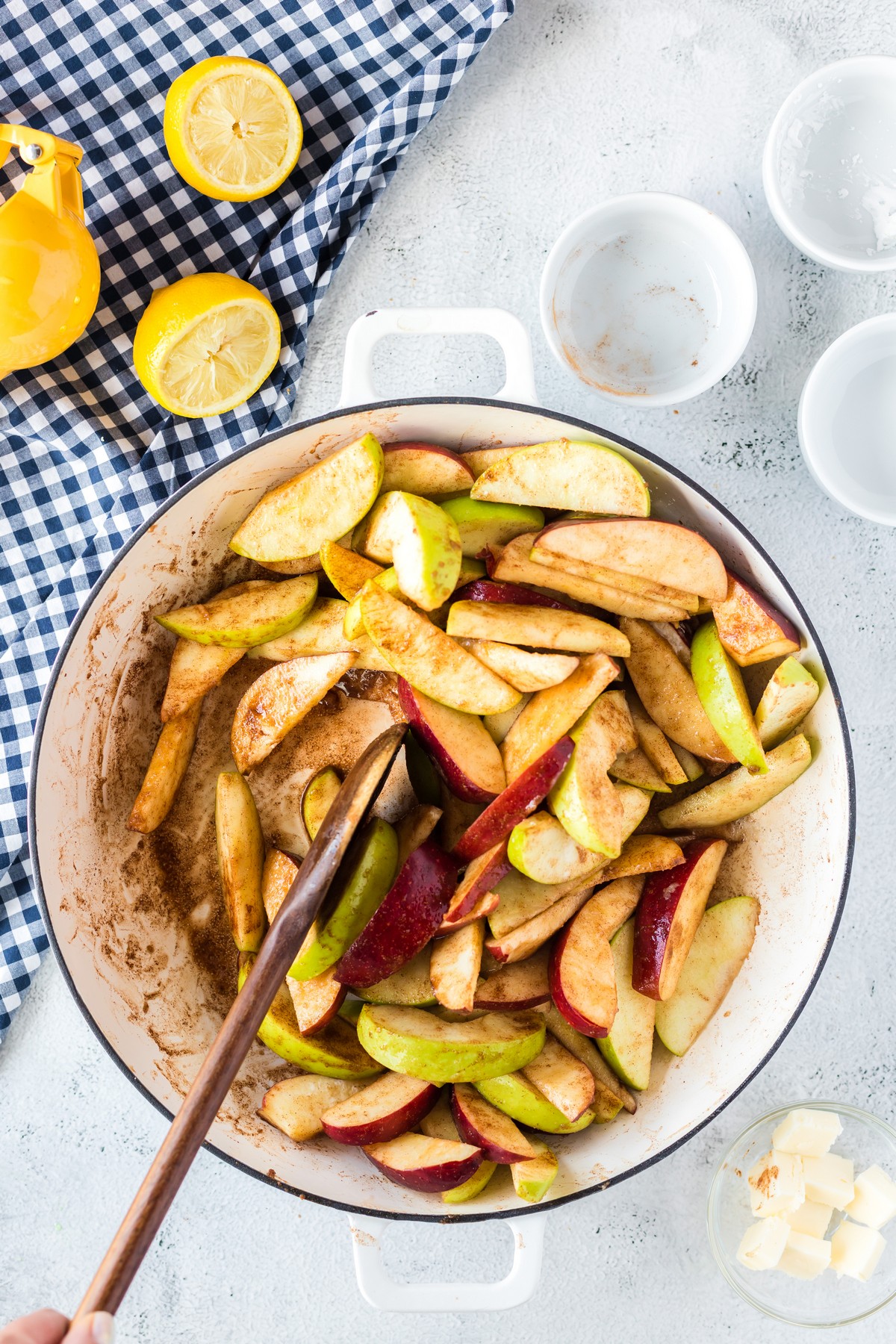 stirring apple slices with cinnamon sugar