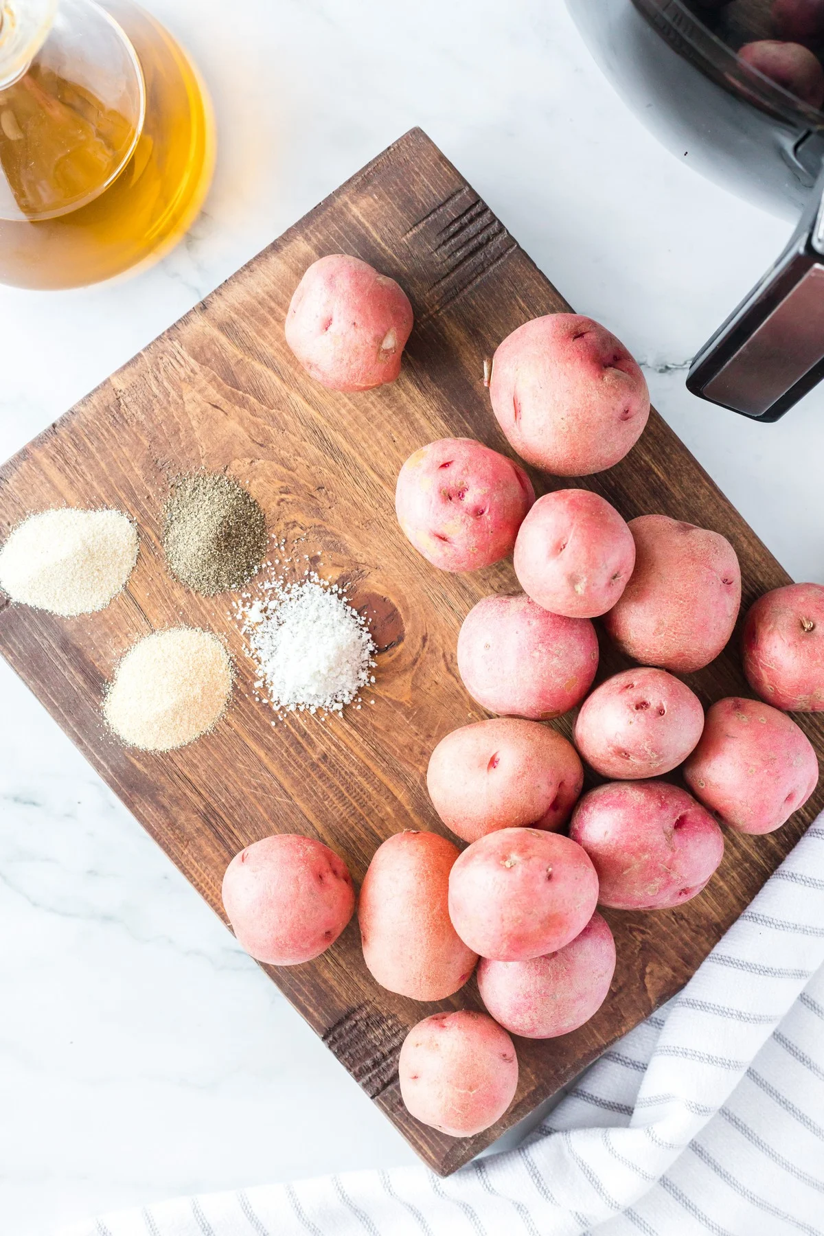 baby red potatoes and seasonings on cutting board