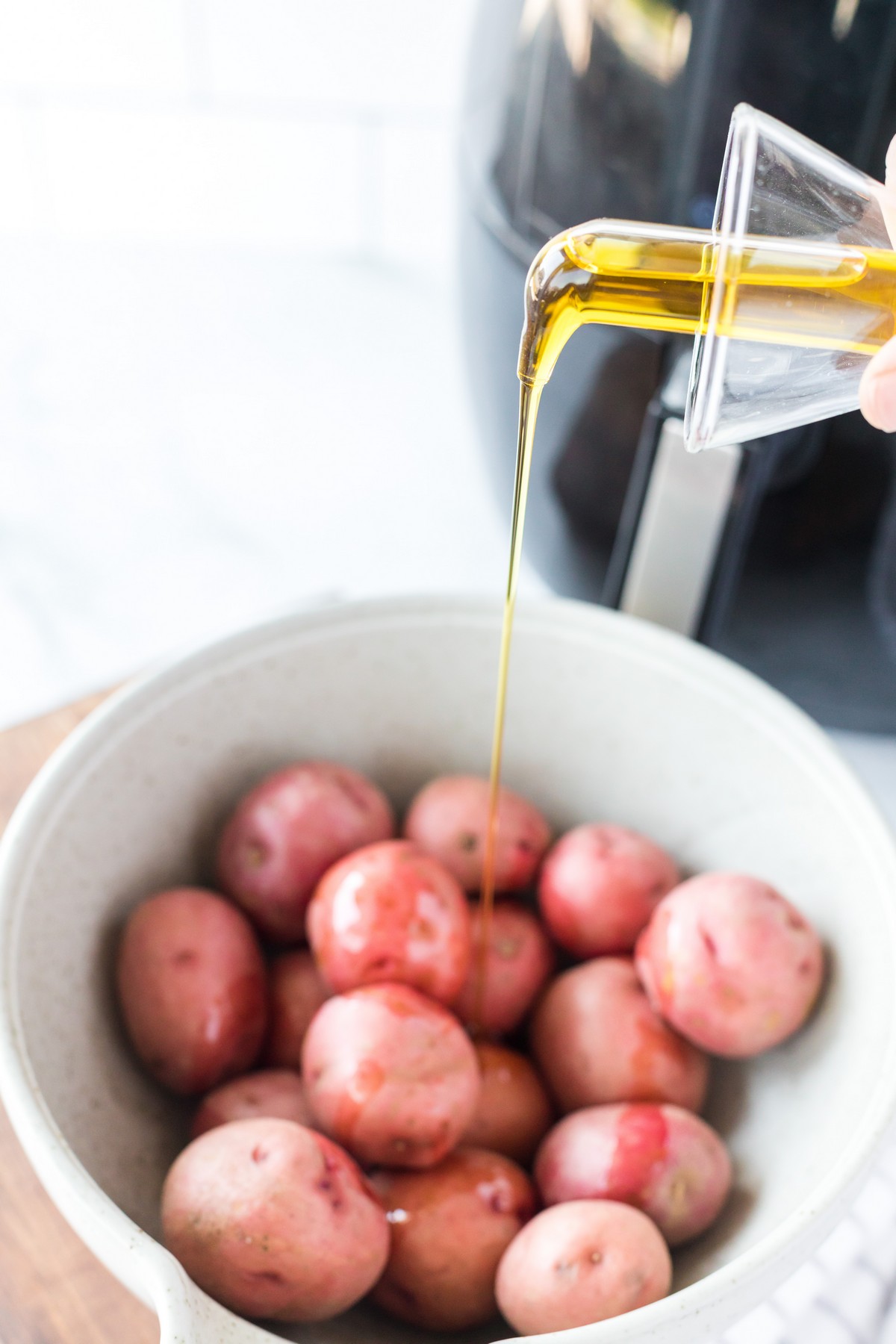 seasoning red potatoes in bowl