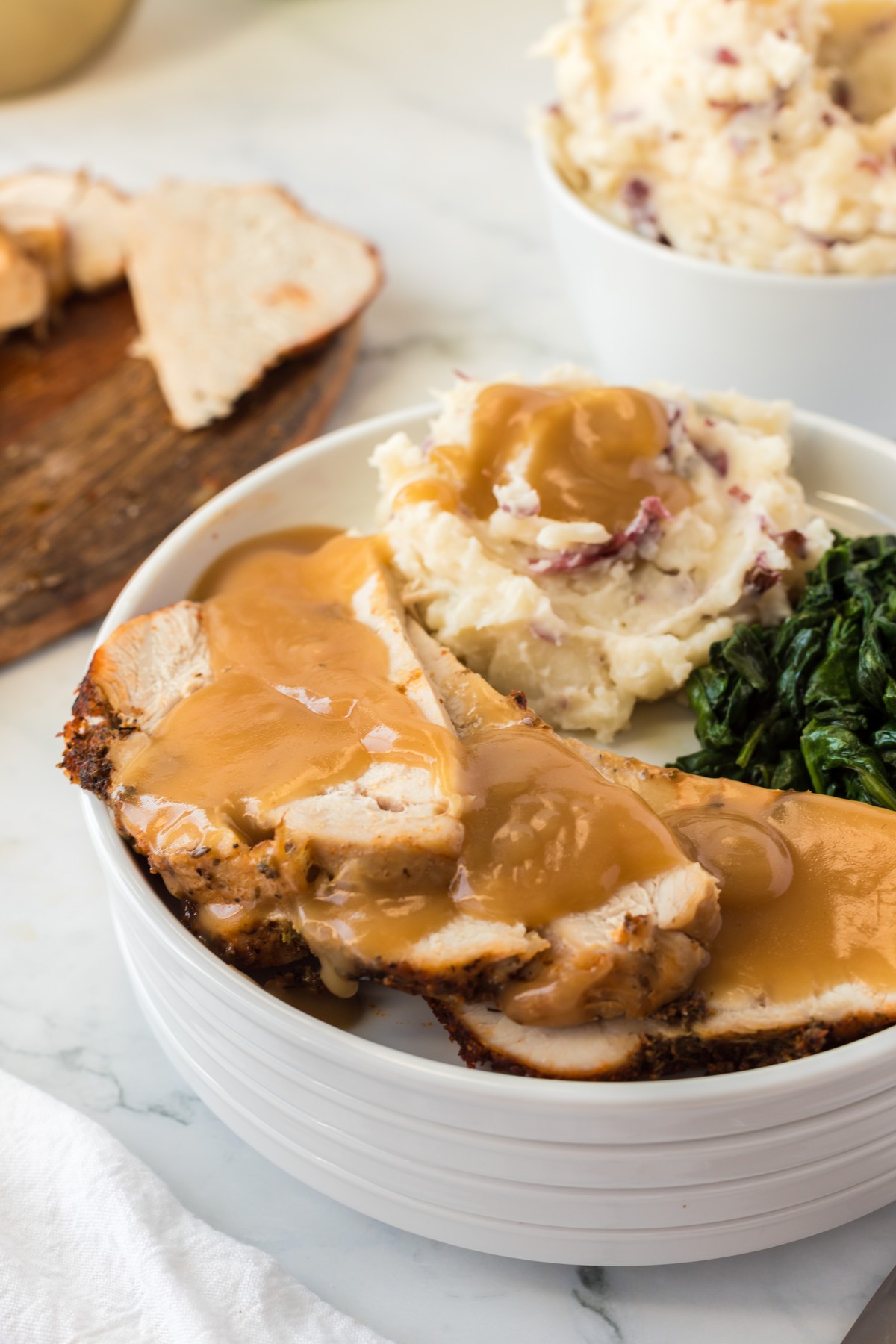 tender and juicy turkey breast with gravy and side dishes