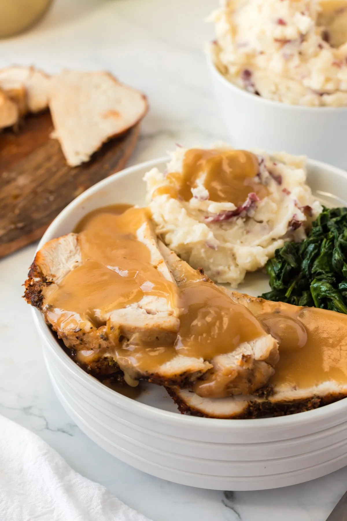 tender and juicy turkey breast with gravy and side dishes