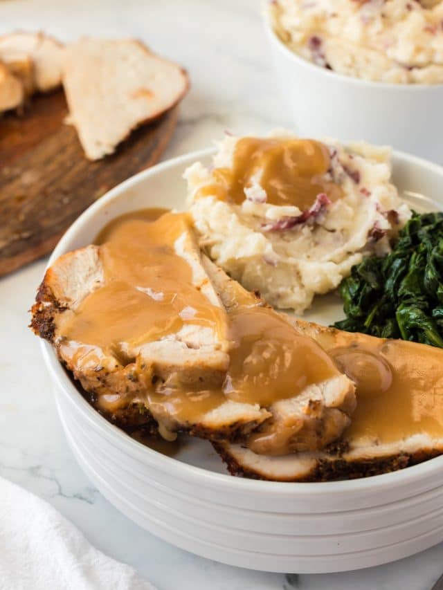 tender and juicy turkey breast with gravy and side dishes