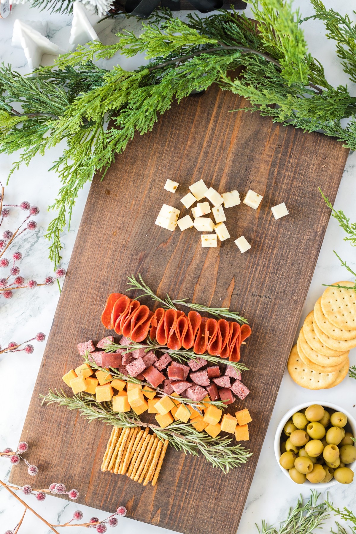 adding meat slices to the Christmas Charcuterie Board