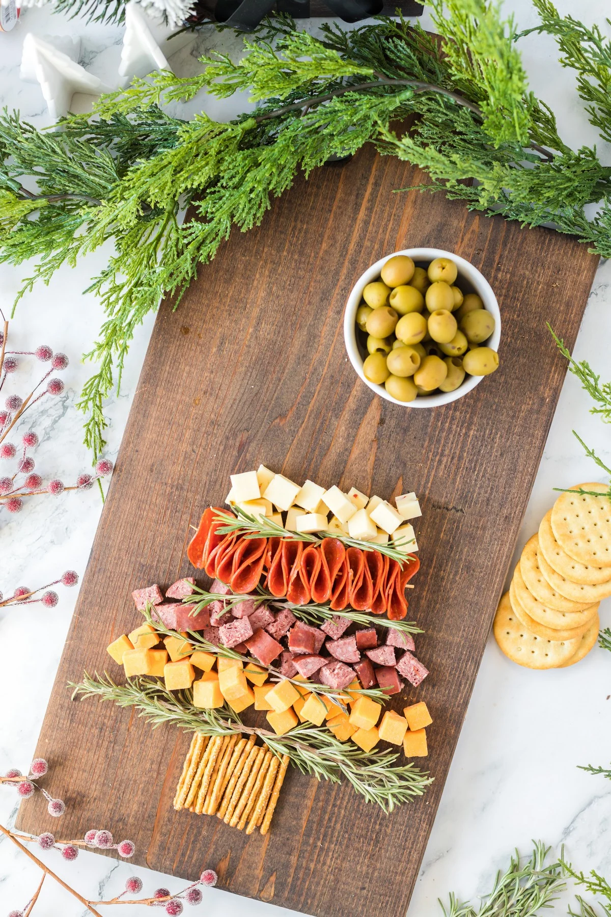 layering food items on a Christmas Charcuterie Board