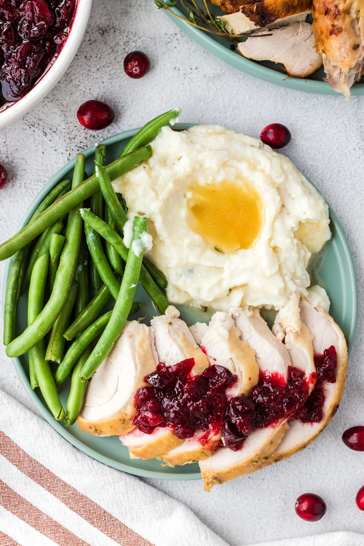 cranberry sauce with turkey, green beans, and mashed potatoes