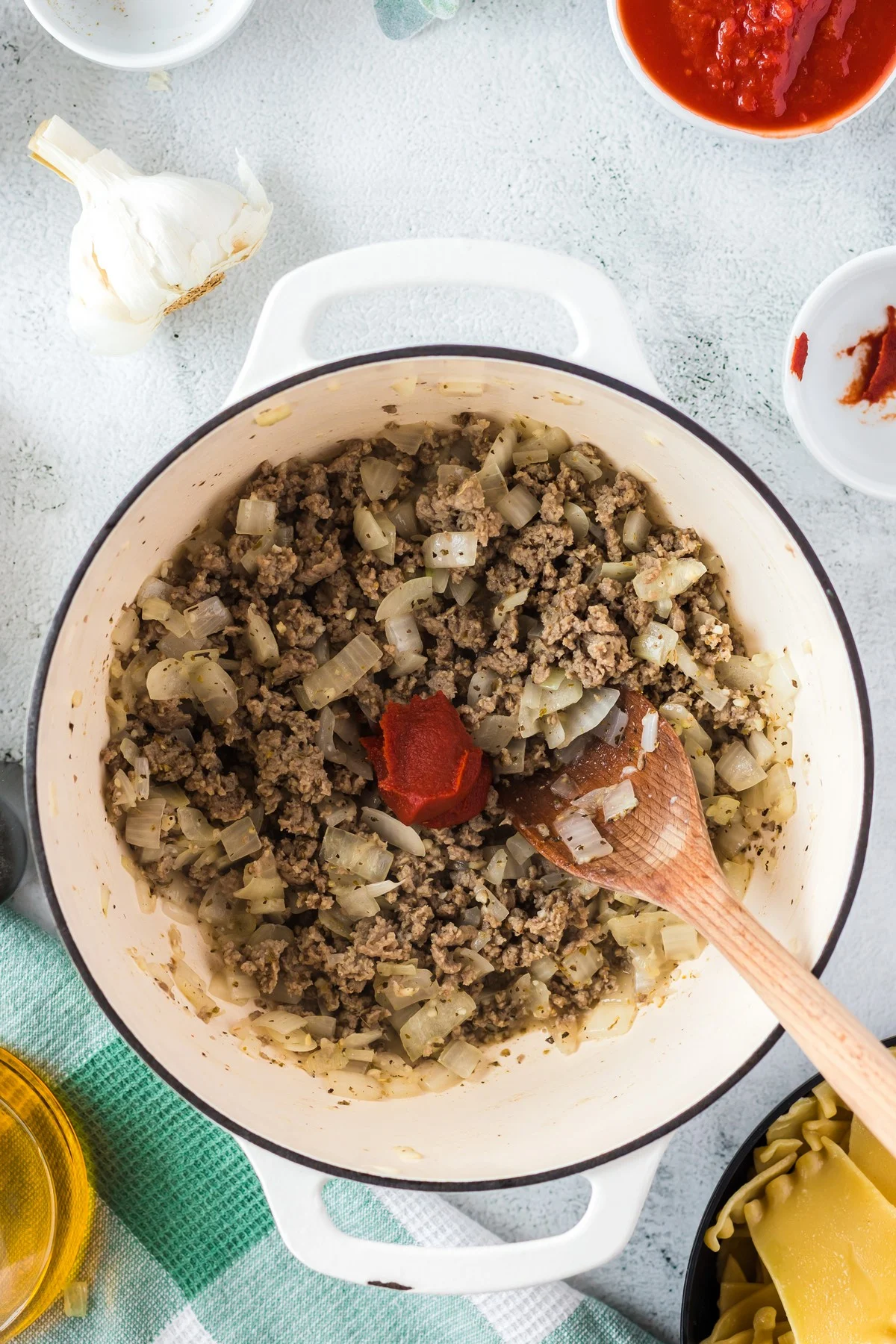 combining herbs and spices in dutch oven to season lasagna soup