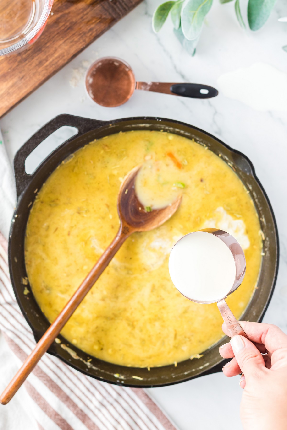 adding heavy cream to make a gravy for turkey pot pie