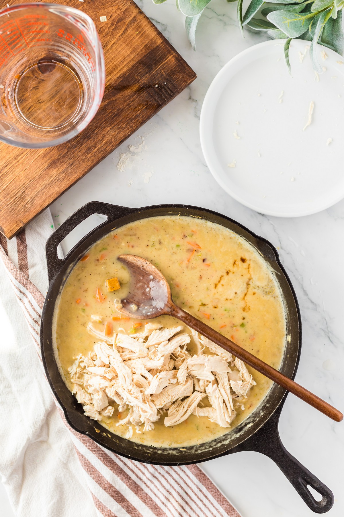 adding shredded chicken to pot pie filling