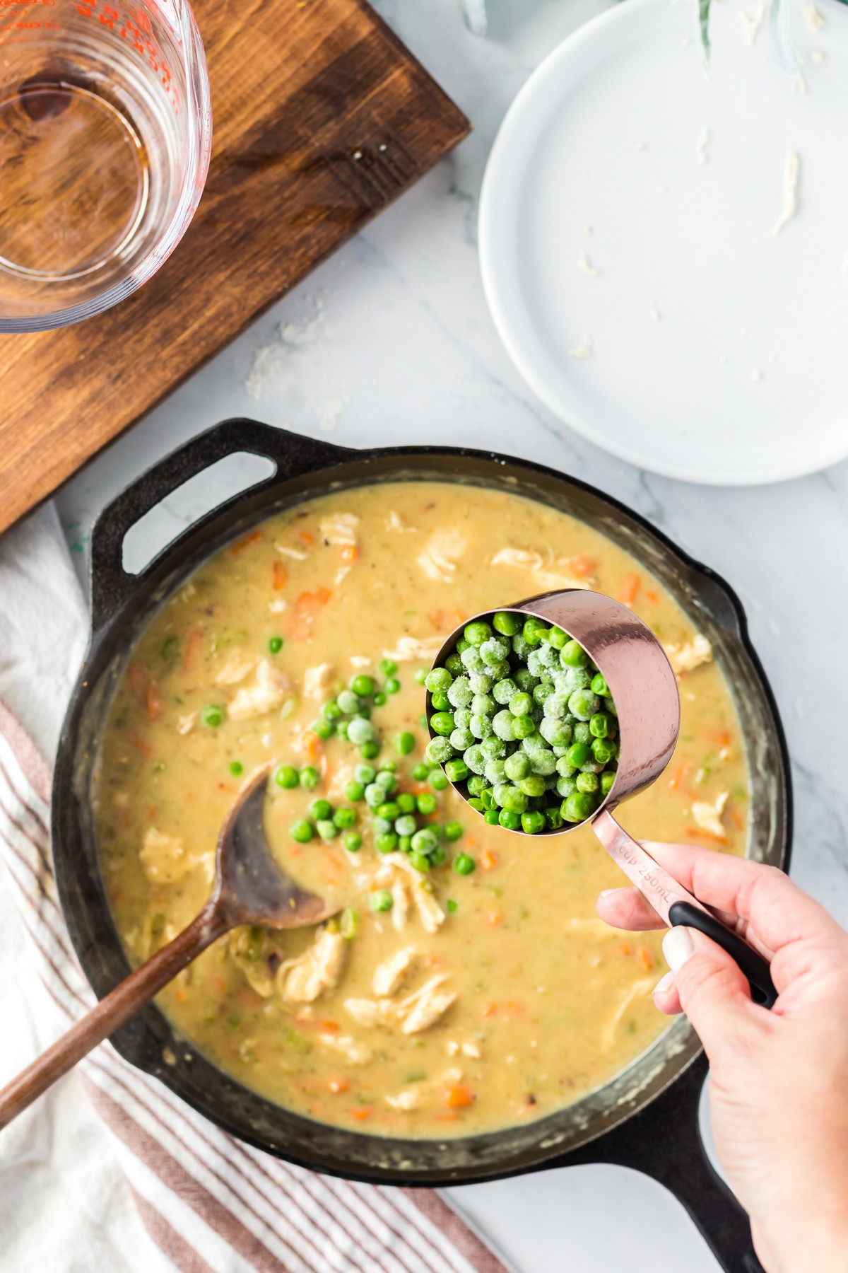 adding green peas to chicken pot pie filling