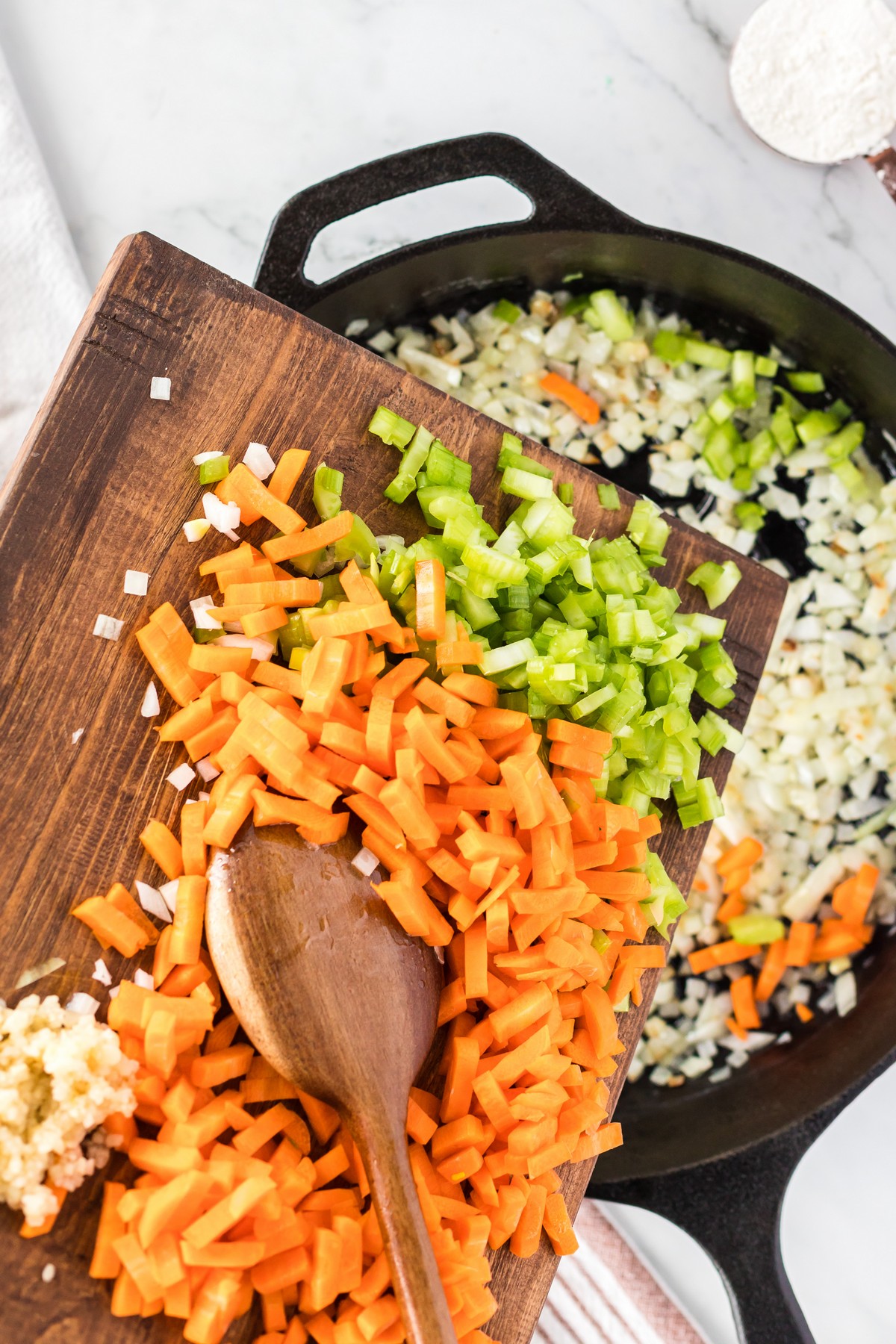 adding carrots and celery to skillet with onion