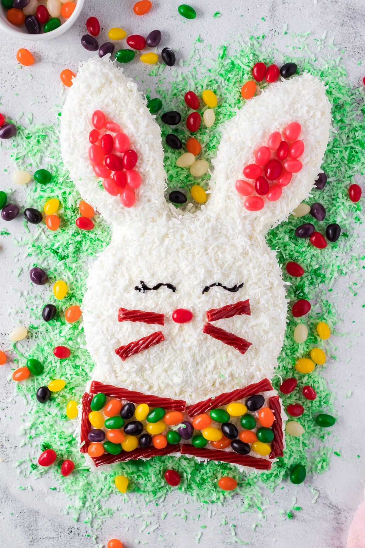 easter bunny shaped cake with green coconut flakes surrounding