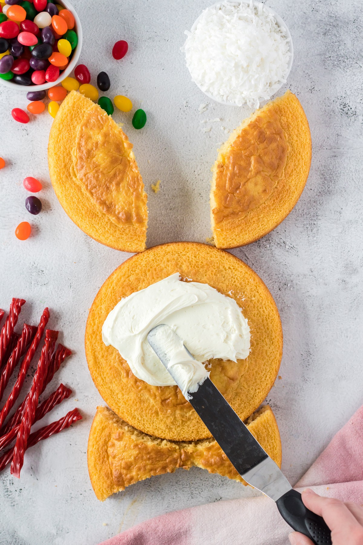 applying frosting to easter bunny cake