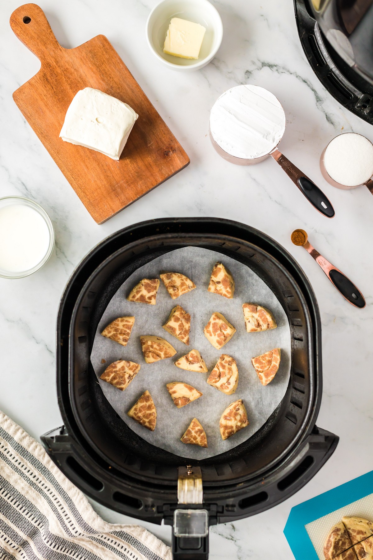adding cinnamon roll pieces to air fryer