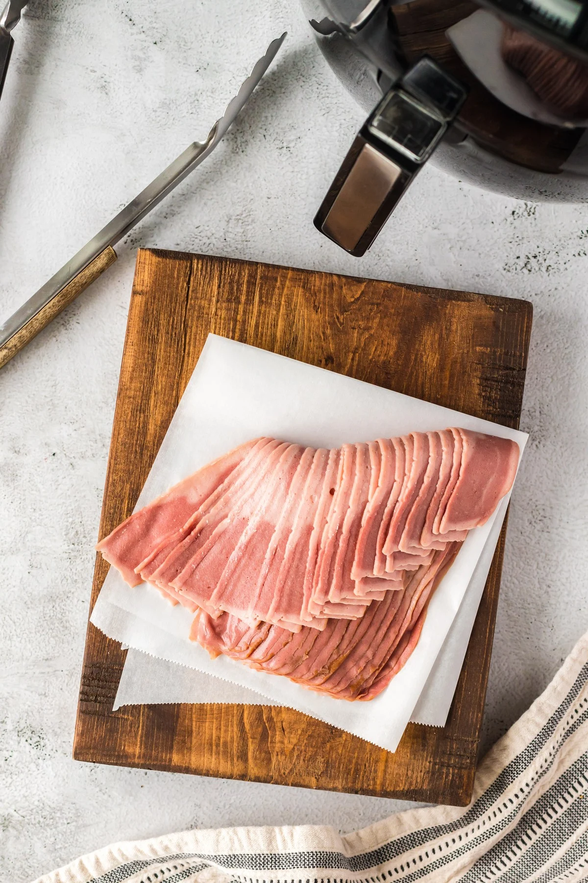 raw bacon on cutting board