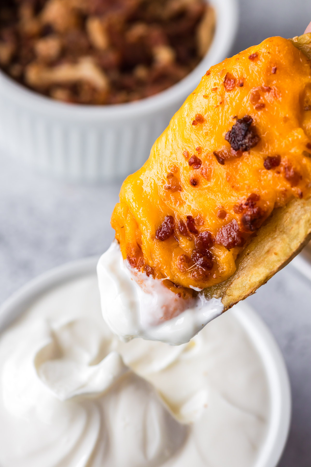 dipping crispy potato skins in sour cream