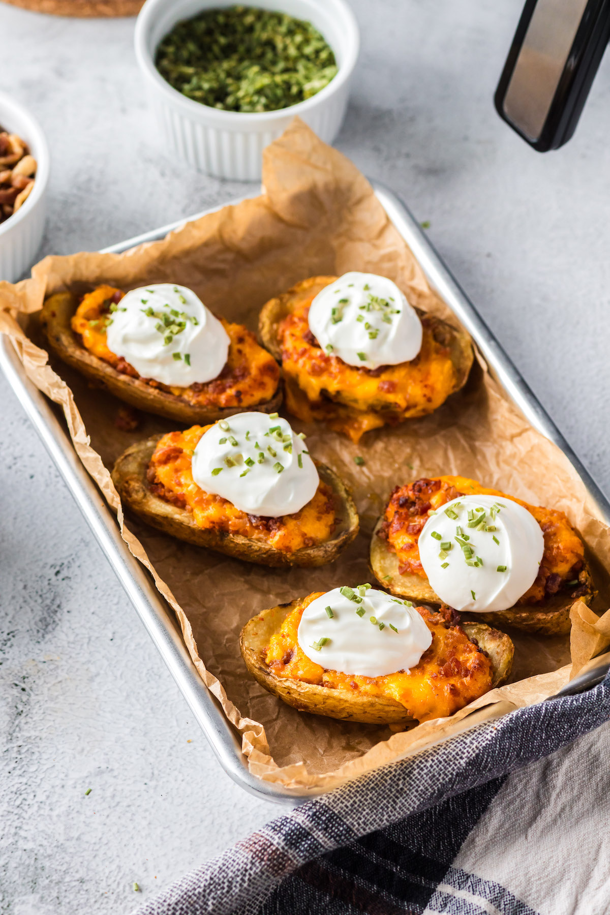 prepared potato skins with sour cream and chive garnish