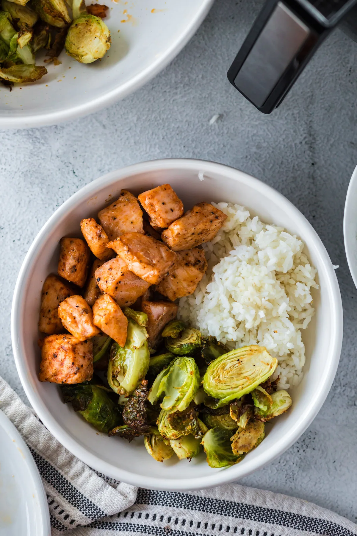 air fryer salmon bites sushi bowl with rice and Brussel sprouts
