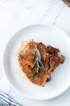 pork chop on plate with rosemary