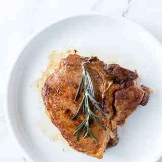 pork chop on plate with rosemary