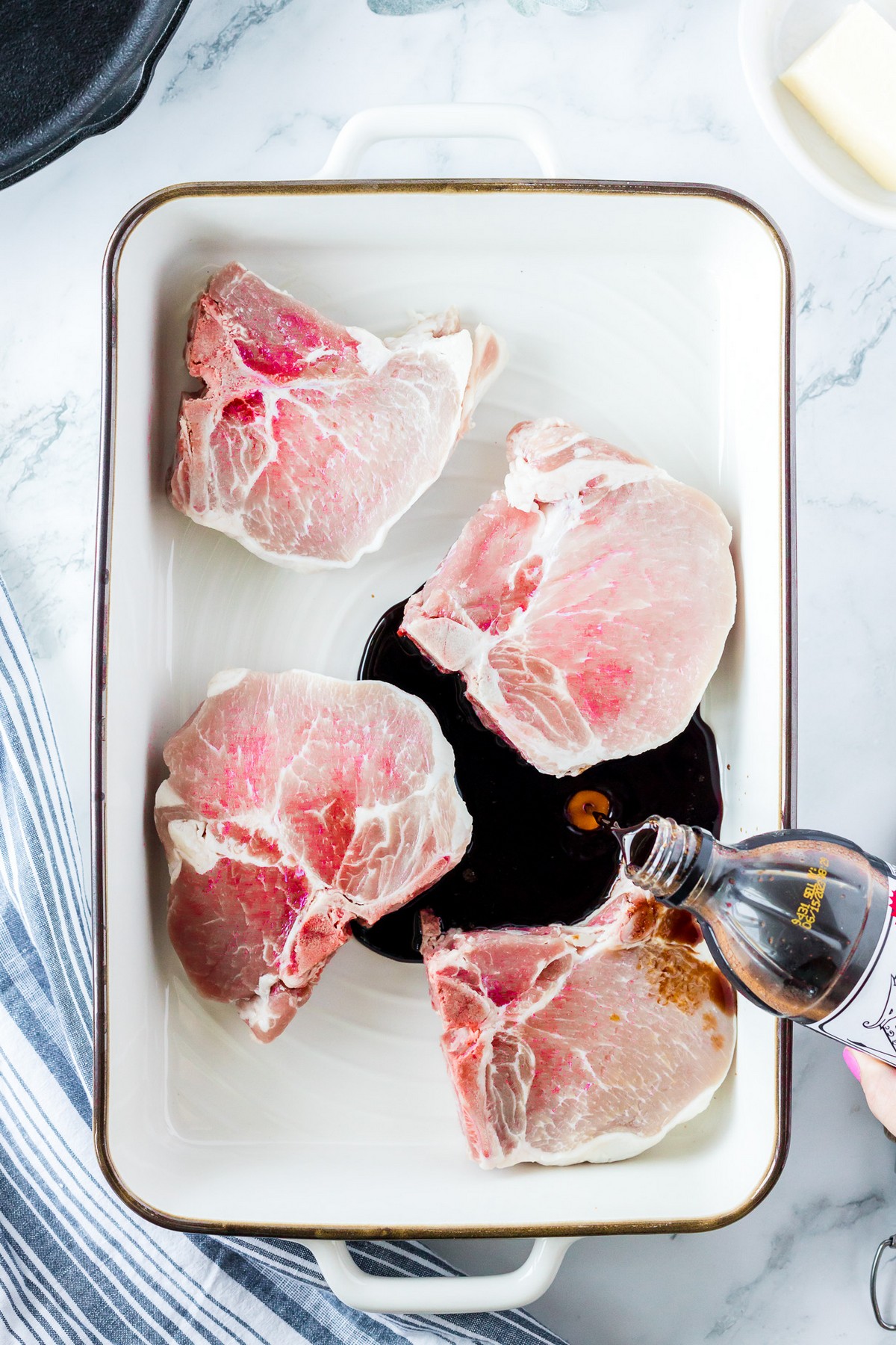 pouring marinade over pork chops