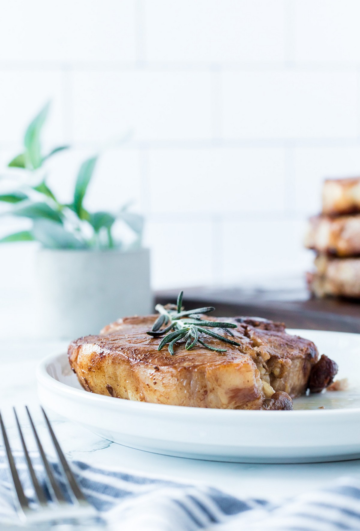 plated pork chop with rosemary
