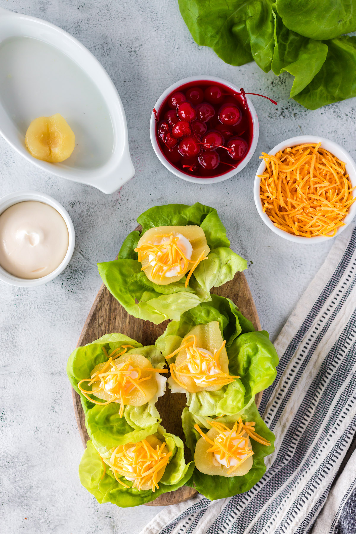 sprinkling cheddar cheese on pear halves