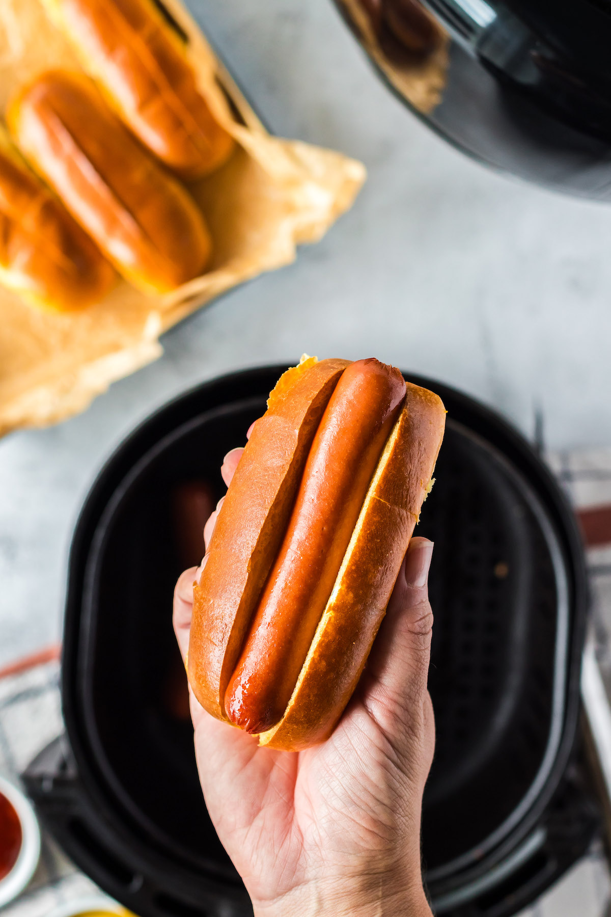 assembling hot dogs with toasted buns