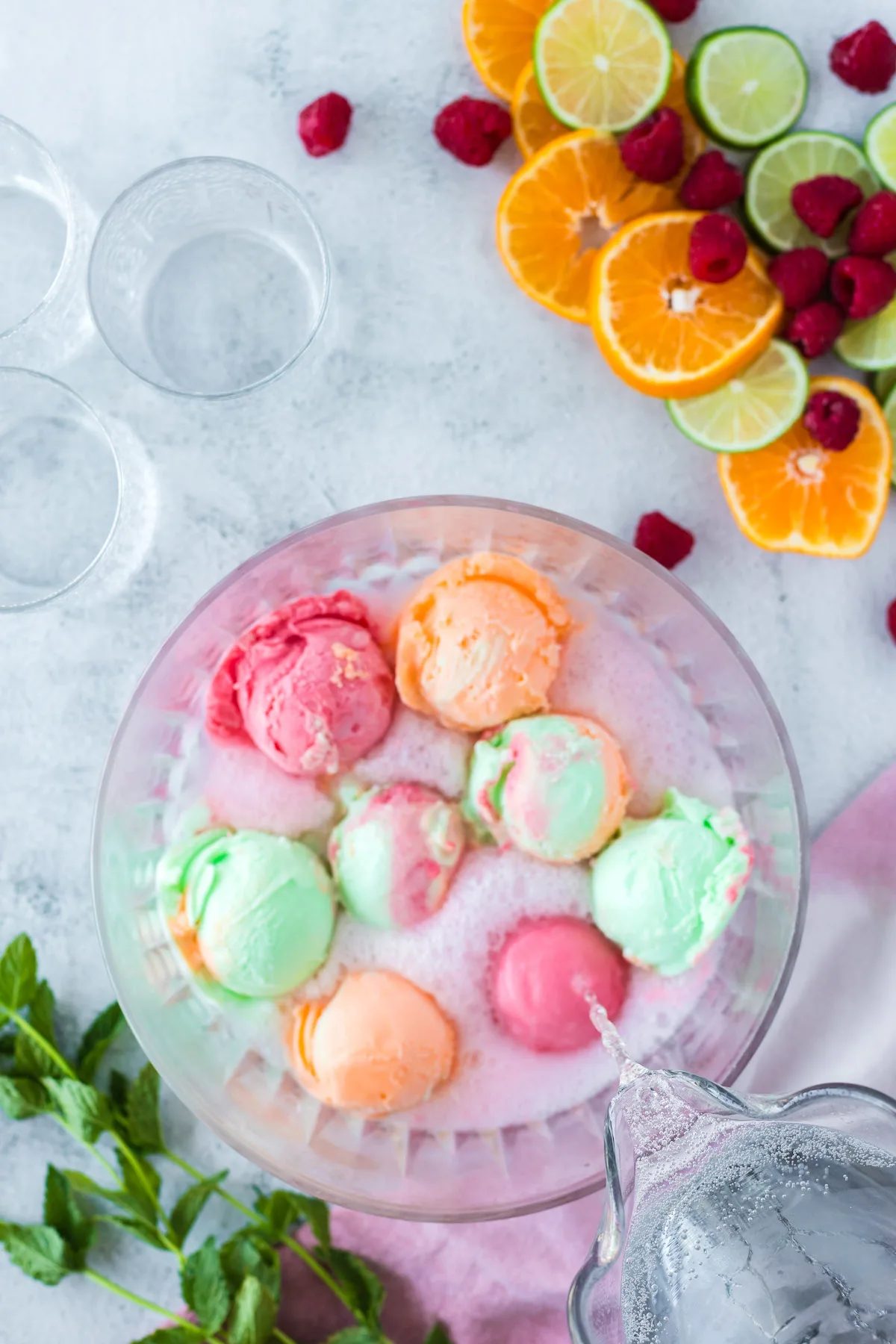 scoops of rainbow sherbet with sprite in a punch bowl