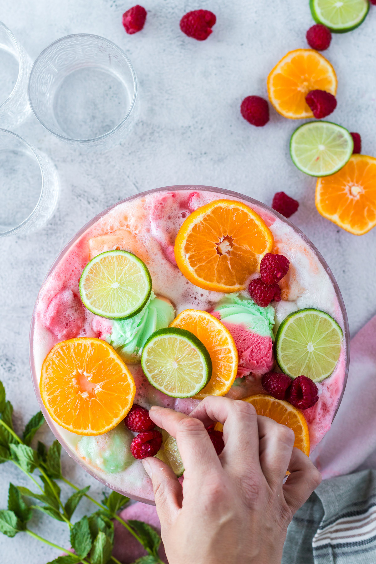 adding garnish to rainbow sherbet punch