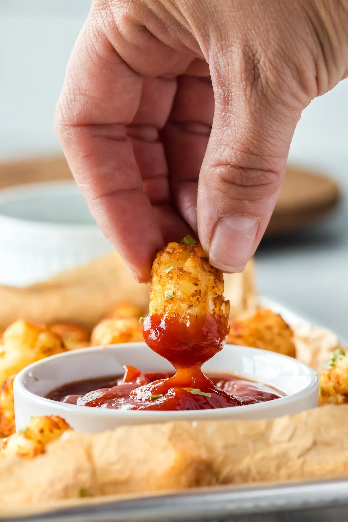 dipping tater tots in ketchup