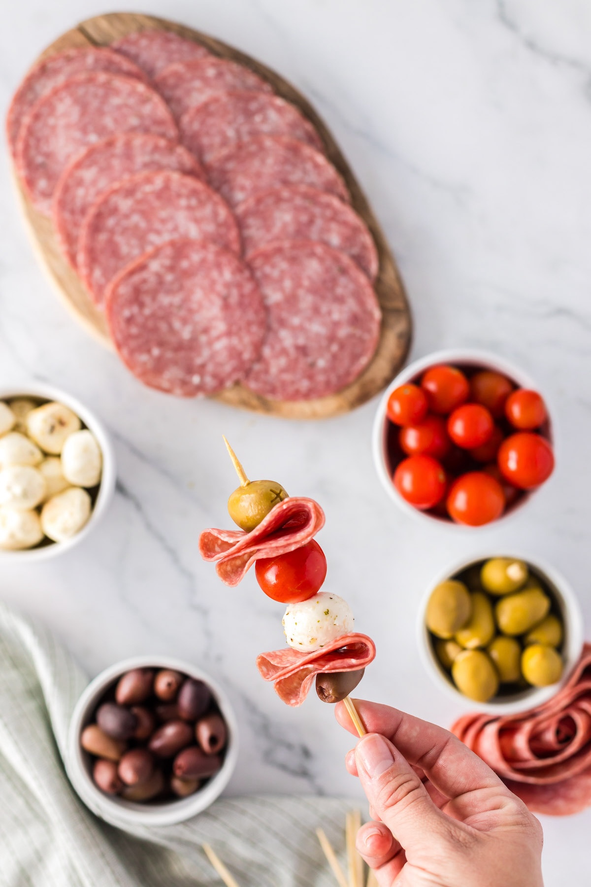 holding charcuterie skewer