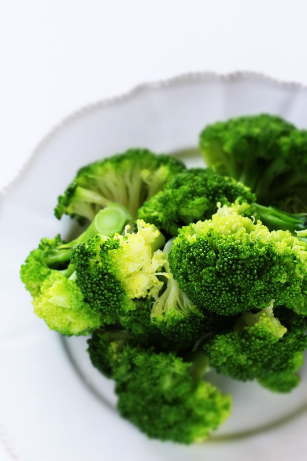 boiled broccoli on white plate