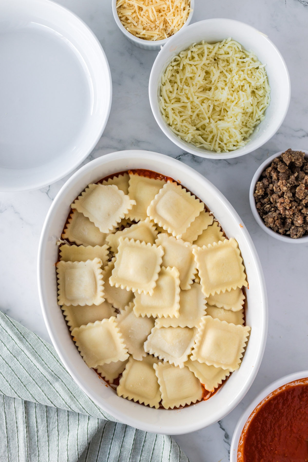 adding final layer of ravioli to casserole