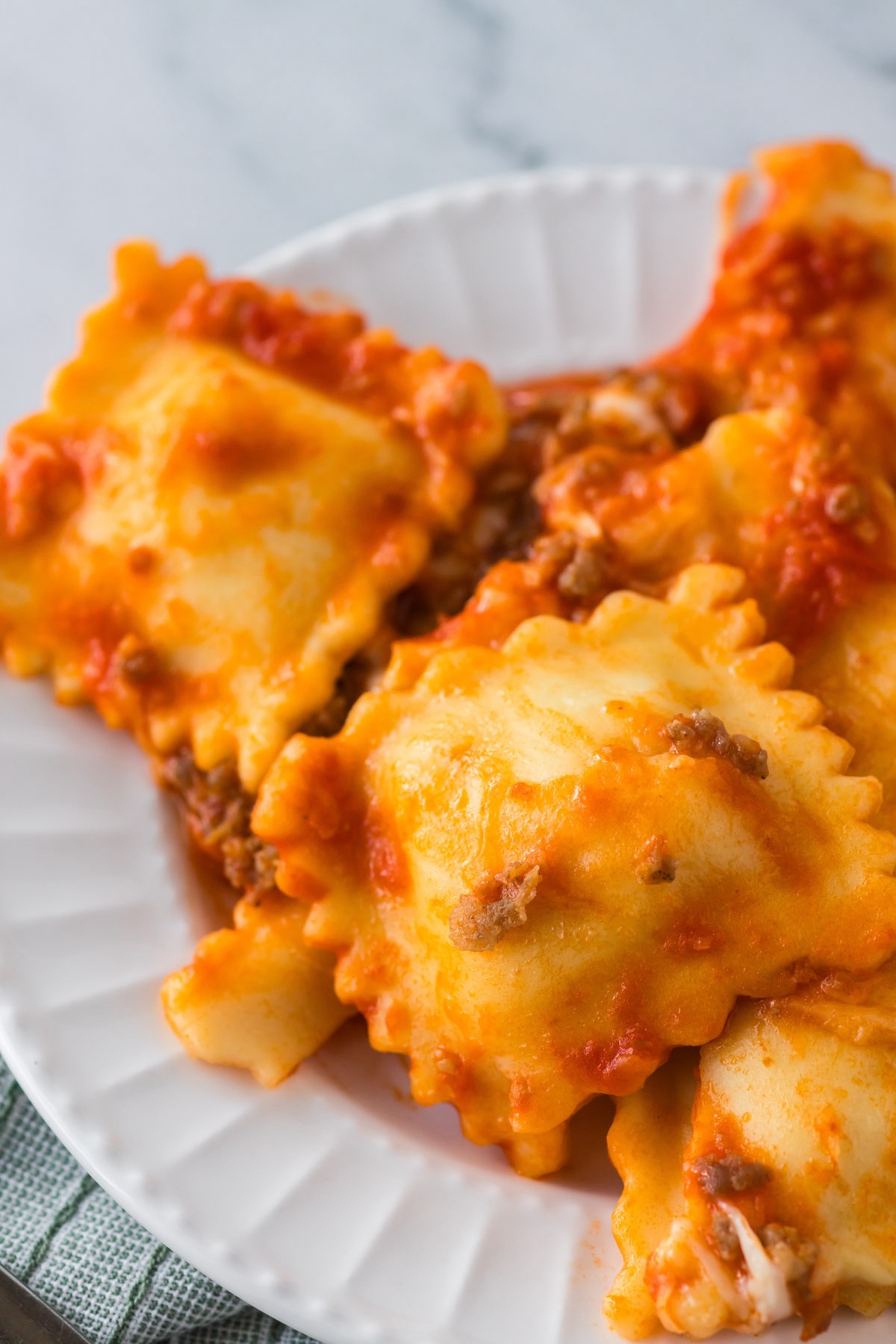 baked ravioli casserole with sauce and Italian sausage