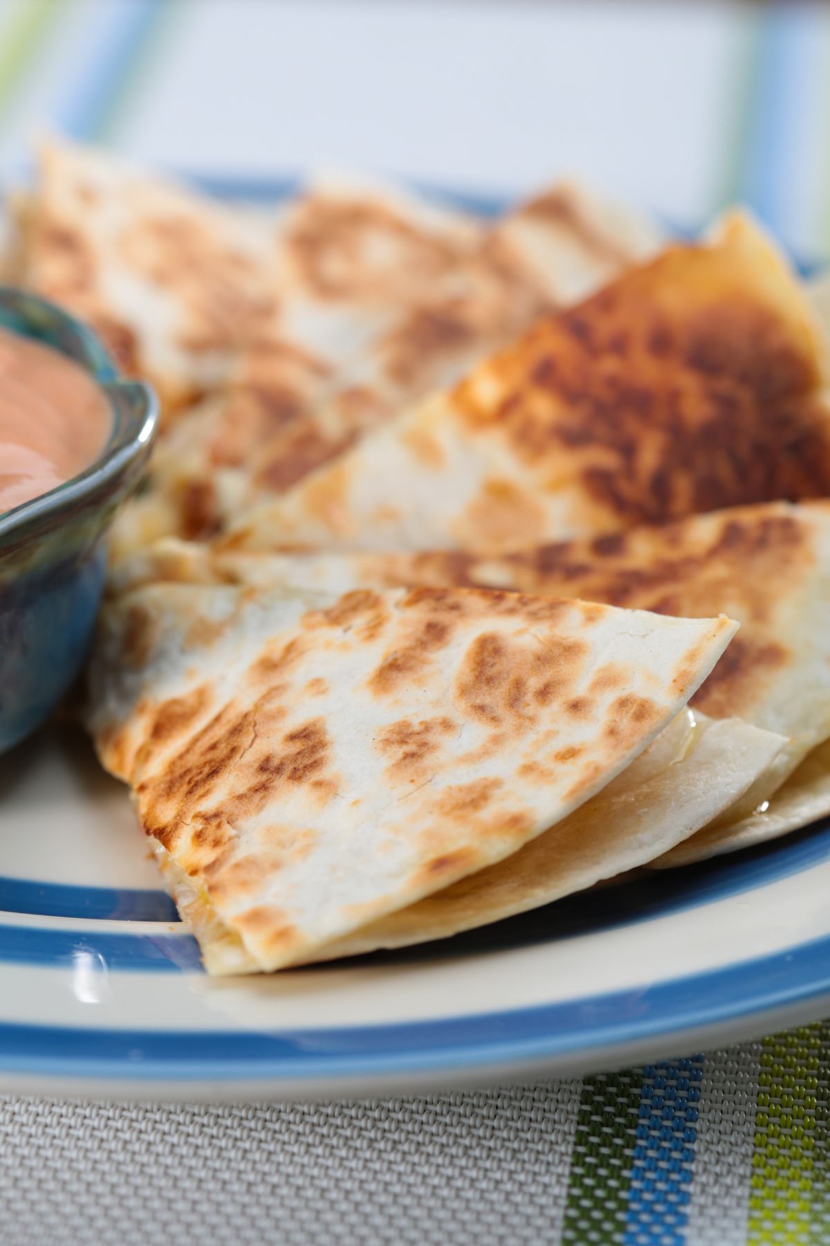 quesadilla sliced and on blue and white plate