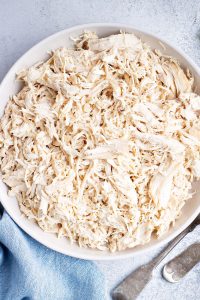 white bowl of shredded chicken