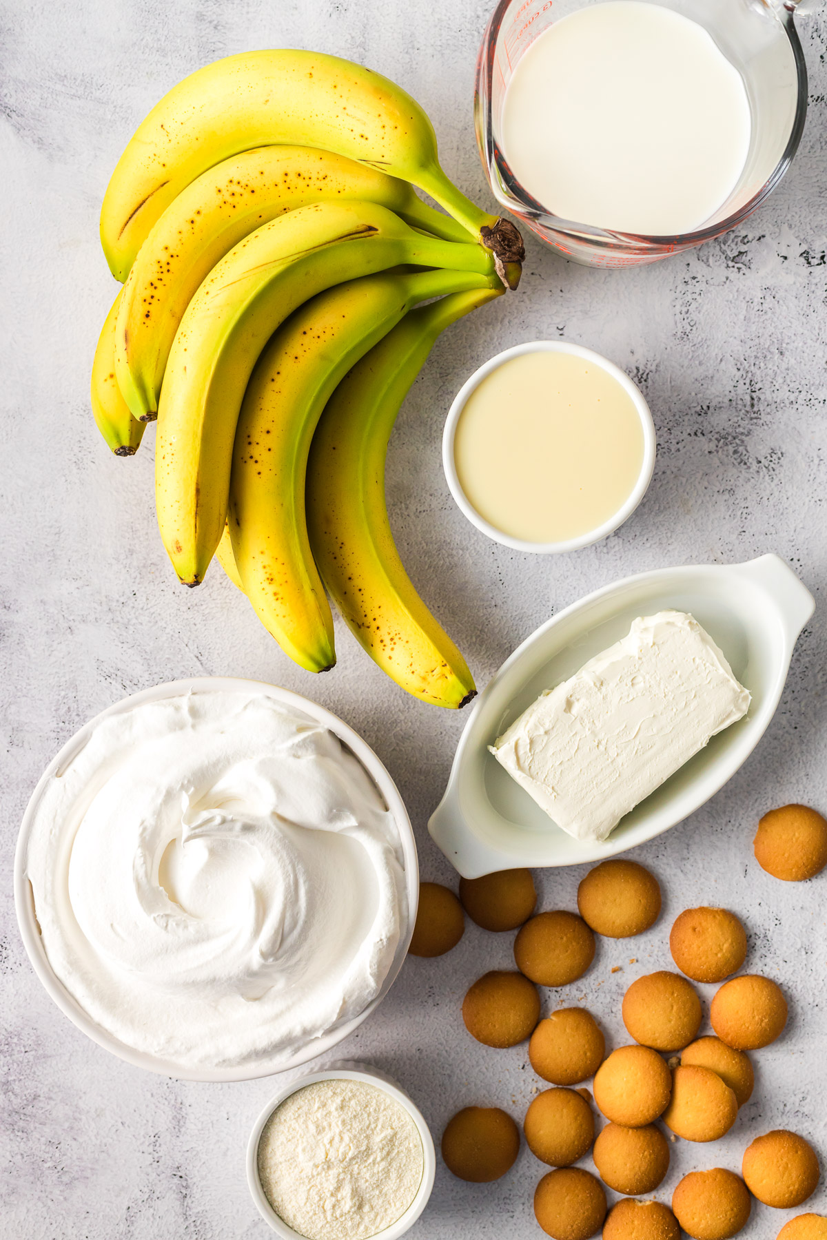 ingredients for banana pudding - bananas, cool whip, Nilla wafers, cream cheese, and sweetened condensed milk