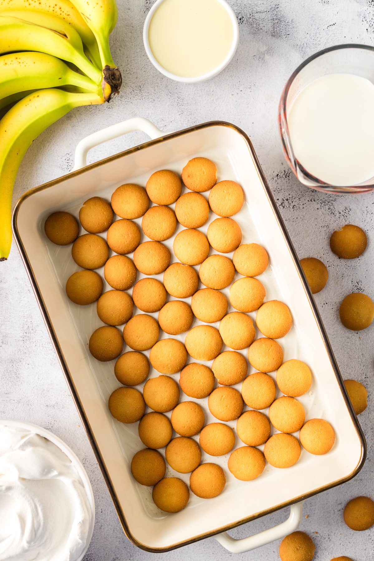 layering Nilla wafers in the bottom of a large pan to make banana pudding