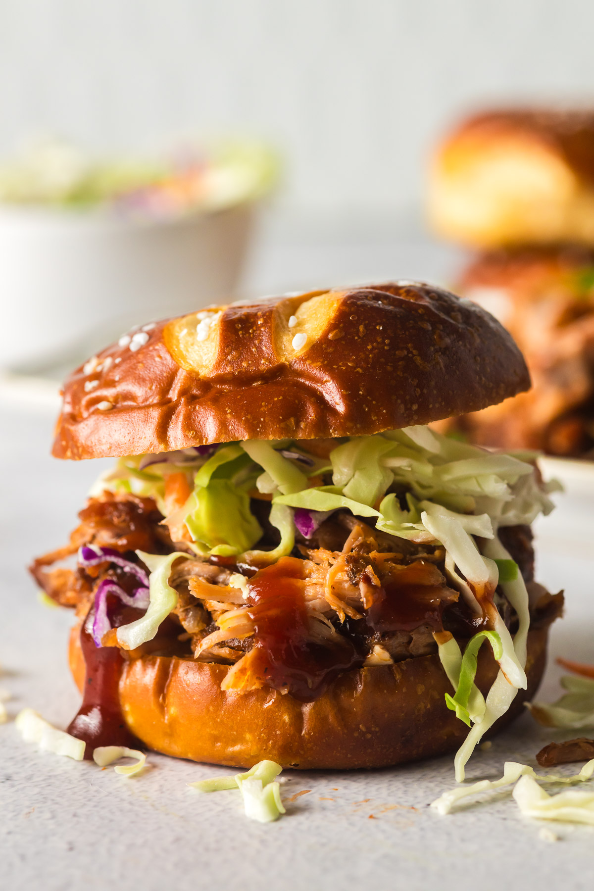 shredded pork on a pretzel bun